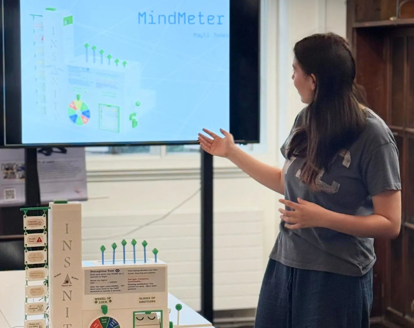 Mayli presenting MindMeter in front of a screen showing its CAD render