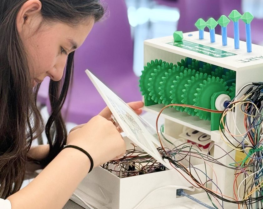 Mayli testing MindMeter's wiring, with the piston gear train exposed